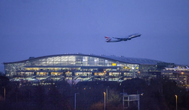 Jet-airplane-taking-off-Terminal-5-Heathrow-Airport-England-night